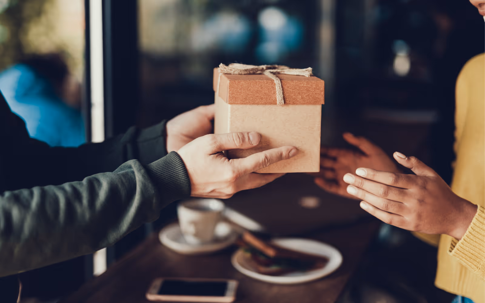 Someone handing a gift to someone else image. 